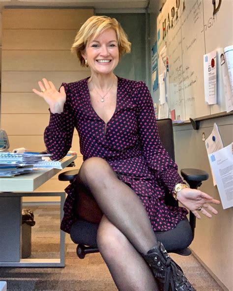 a woman sitting in an office chair waving