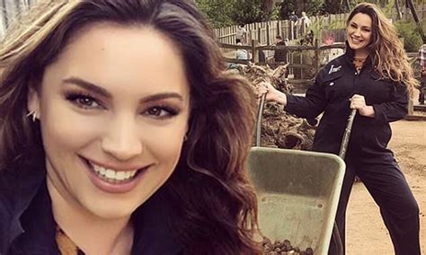 kelly brook slips her curves into a blue boiler suit as she spends the