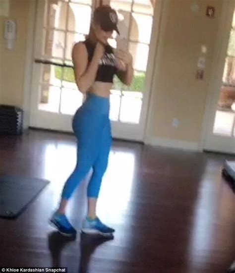 khloe kardashian flashes flat stomach in skintight workout wear on