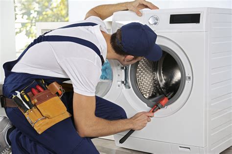 4 common problems with washing machines and how to fix them man with a wrench