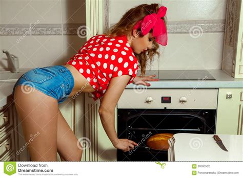 Charming Girl Bakes Bread In Clothes Pin Up Style Stock