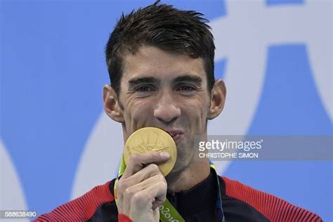 topshot usa s michael phelps poses with his gold medal on the