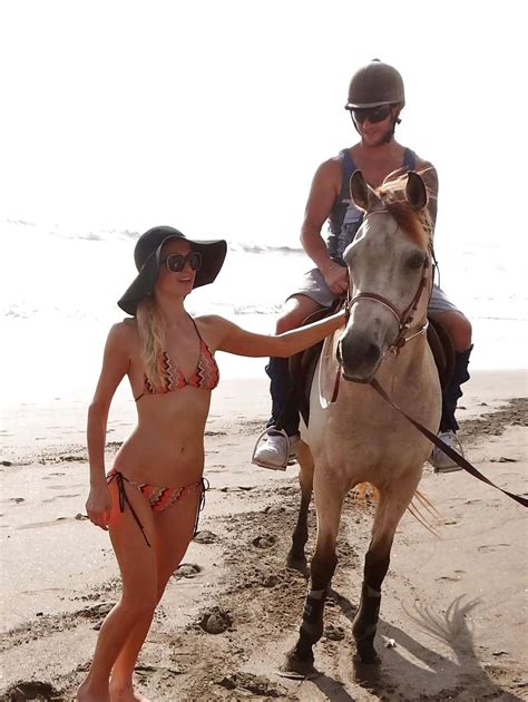 paris hilton in skimpy bikini and black hat on beach paparazzi pictures