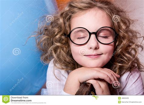 portrait of teen girl dreaming in glasses with eyes closed again stock