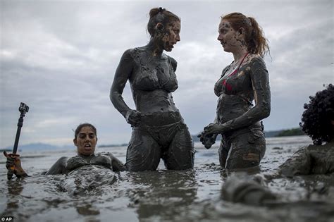 revellers flood seaside for brazilian mud street party
