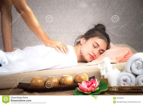 thai masseuse doing massage for woman in spa salon asian