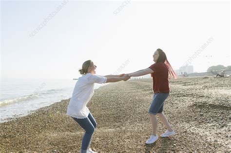 Playful Lesbian Couple Holding Hands And Spinning Stock Image F023