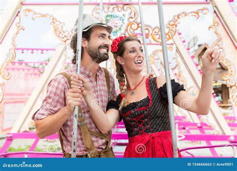 Woman And Man Enjoying A Swing On The Oktoberfest Stock Image Image