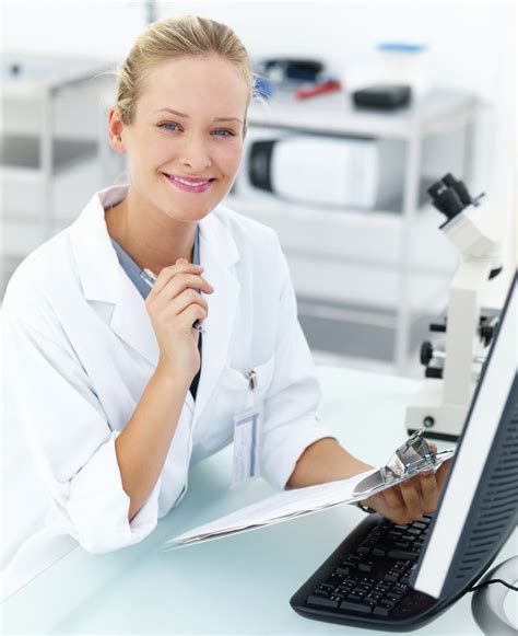 smiling female researcher sitting   laboratory  writing
