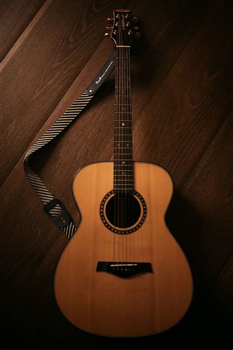 brown acoustic guitar  brown wooden floor photo  guitar image  unsplash acoustic