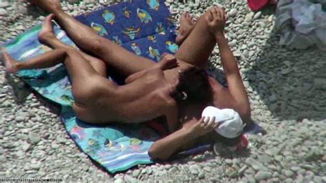 sunburned milf wife gives her man a handjob on beach spy