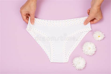 womenand x27 s hands with beautiful panties and sanitary pads on pink