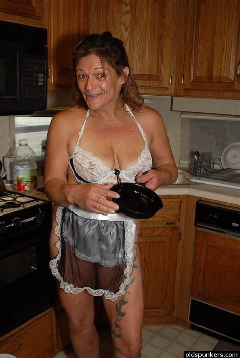 granny ivee showing off tattoos and shaved mature vagina in kitchen