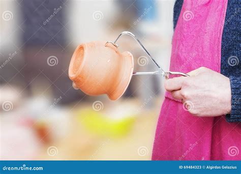 man holding  clay pot  special pincers stock image image