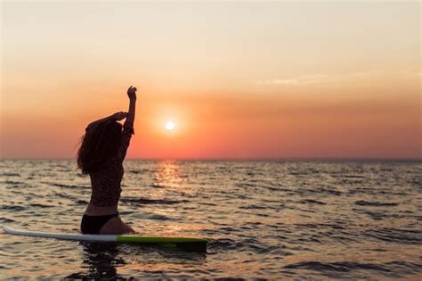 Premium Photo Surfer Girl Surfing Looking At Ocean Beach Sunset