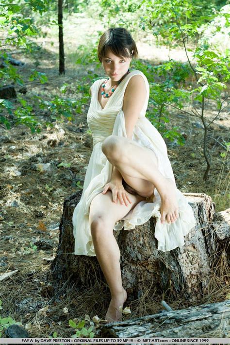 alluring hairy girl fay a in white dress shows off her beaver in the forest