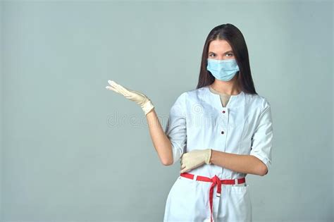 A Female Doctor In A Medical Gown Warns About Something Important