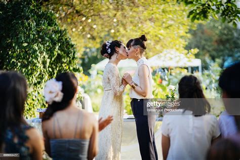 lesbian couple kissing at their wedding ceremony photo getty images