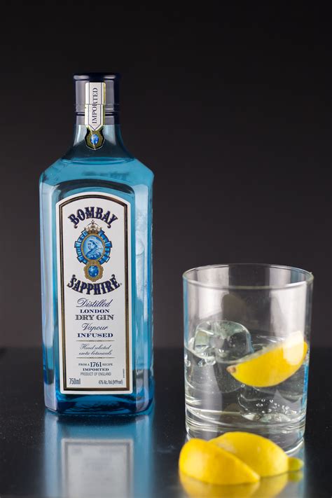 bottle  vodka    glass filled  ice  lemon wedges