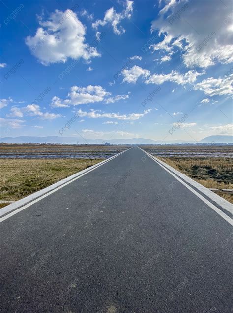 straight asphalt road  blue sky  white clouds background