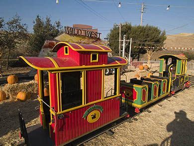 small train  painted red yellow  green  pumpkins