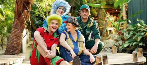 people dressed  costumes posing   photo   wooden platform  trees  plants