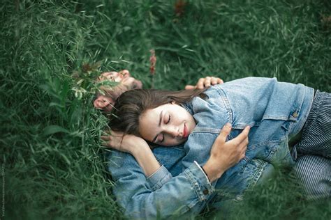 «young Couple Sleeping On A Grass Del Colaborador De Stocksy «yurii
