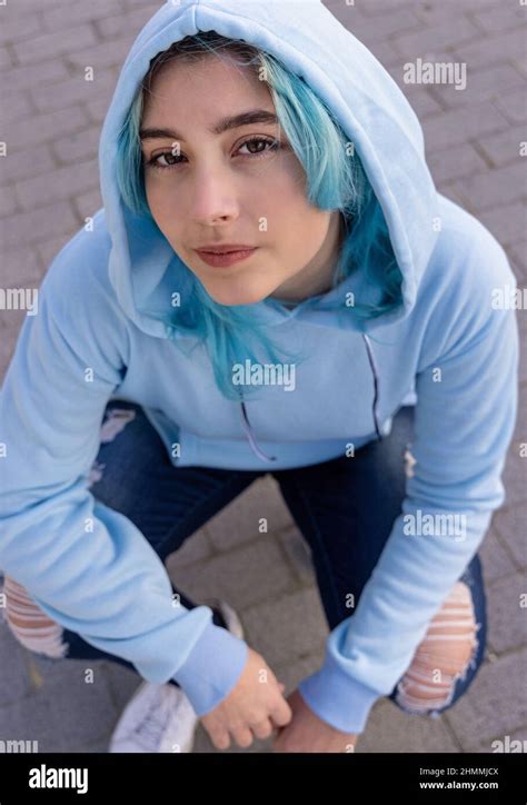 blue haired teenage girl  light blue oversize hoodie