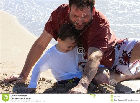 Dad And Son Playing At The Beach Royalty Free Stock Images
