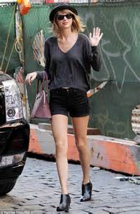leggy taylor swift towers above the pavement in tiny denim shorts