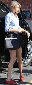 taylor swift shows off her long legs in a tiny black mini skirt daily