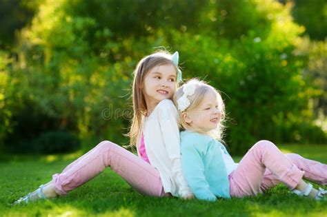 Two Cute Little Sisters Having Fun On The Grass Stock Image Image Of