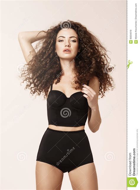 beautiful girl with flying curly hair in black retro