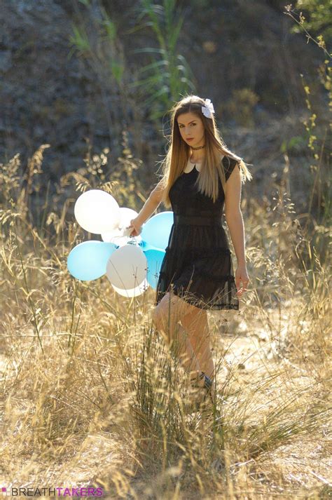 stella cox posing naked with balloons outdoors