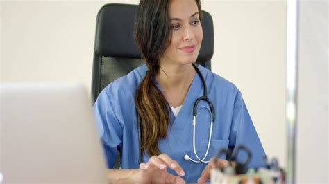 beautiful female doctor with stethoscope grinning while