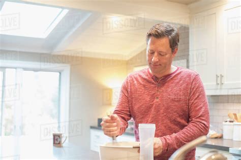 caucasian man mixing food  bowl stock photo dissolve