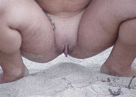 Babe Getting Naked On The Beach Has A Freakish Big Clits