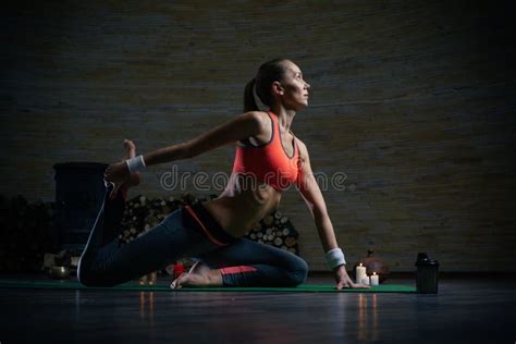 Calm Woman Stretching Her Legs And Touching Foot While Practicing Yoga