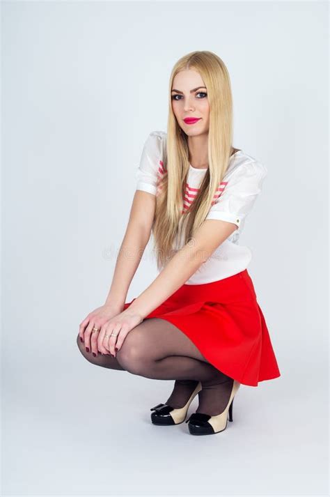 beautiful leggy blonde posing on a gray background stock image image