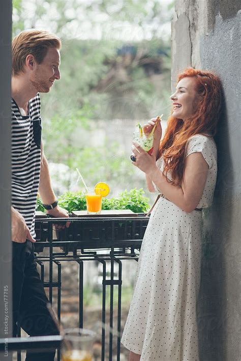 Ginger Couple Having A Drink On A Balcony By Stocksy Contributor