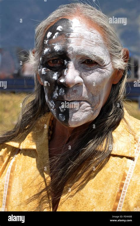 A Face Painted Native American Shaman With Half Black
