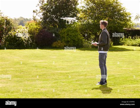 man flying drone quadcopter  garden stock photo alamy