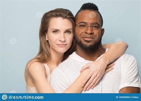 happy multiracial couple look at camera posing together stock image