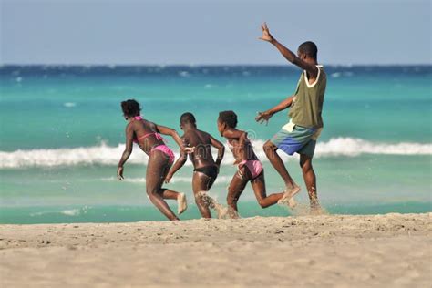 daddy runs  happy kids  coastline editorial stock photo image