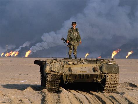 american soldier standing  top   destroyed iraqi tank  oil