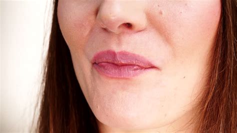 woman licking lips in front of strawberry super slow