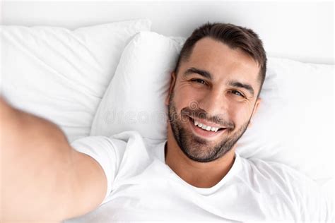 Smiling Glad Millennial Muscular Caucasian Man Waking Up Taking Selfie