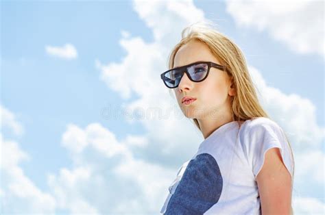 Summer Portrait Of A Blonde Girl In Sunglasses On A Background Of The