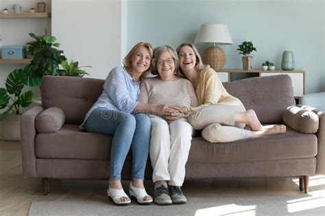 Old Grandma And Young Adult Granddaughter Talking Bonding On Sofa Stock