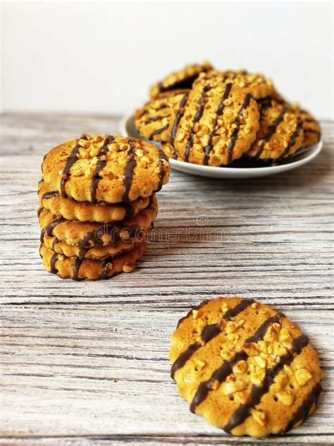 cookies poured with chocolate and pieces of peanuts is a slide on a